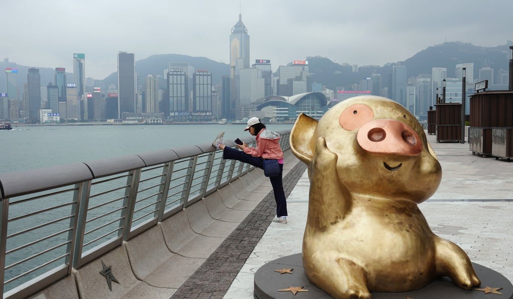 A woman stretches at the Tsim Sha Tsui Promenade in Hong Kong amid the coronavirus outbreak. Photo: SCMP / Sam Tsang