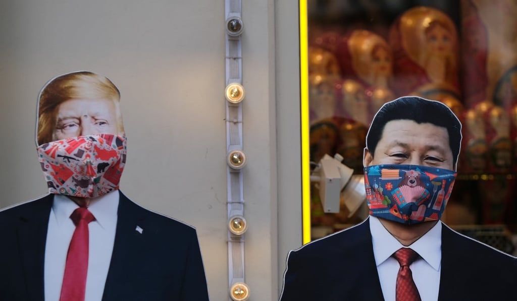 Cut-outs of US leader Donald Trump, and Chinese president Xi Jinping in masks outside a gift shop in Moscow, Russia. Photo: Reuters