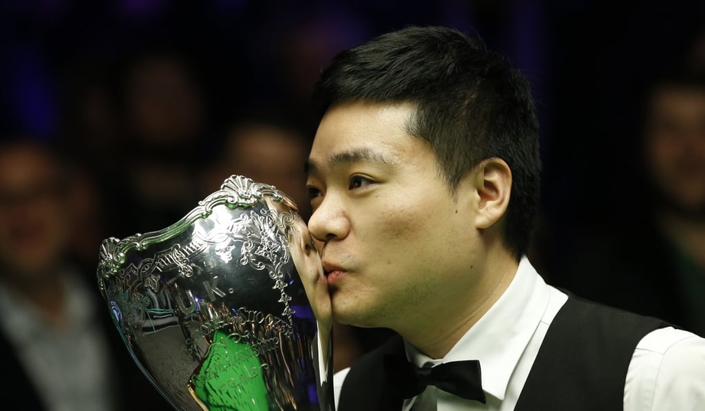 Ding Junhui kisses his trophy after winning his third UK Championship in York in December. Photo: Xinhua