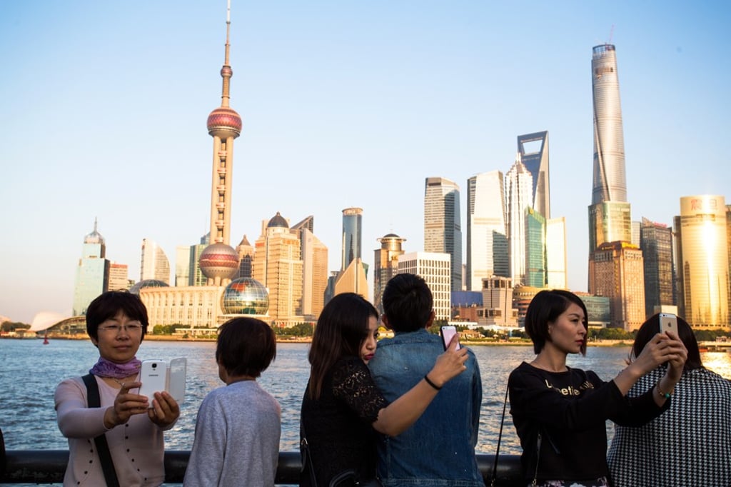 Tourists take selfies with the Oriental Pearl Tower on the Bund in Shanghai, China. Only keep the photos you really like and ditch the rest. Photo: Getty Images Tourists take selfies with the Oriental Pearl Tower on the Bund in Shanghai, China. Only keep the photos you really like and ditch the rest. Photo: Getty Images