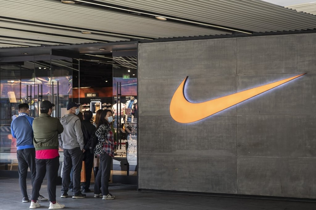 Shoppers queue to enter the Nike store at Sanlitun Taikoo Place in Beijing on March 17. Photo: Bloomberg