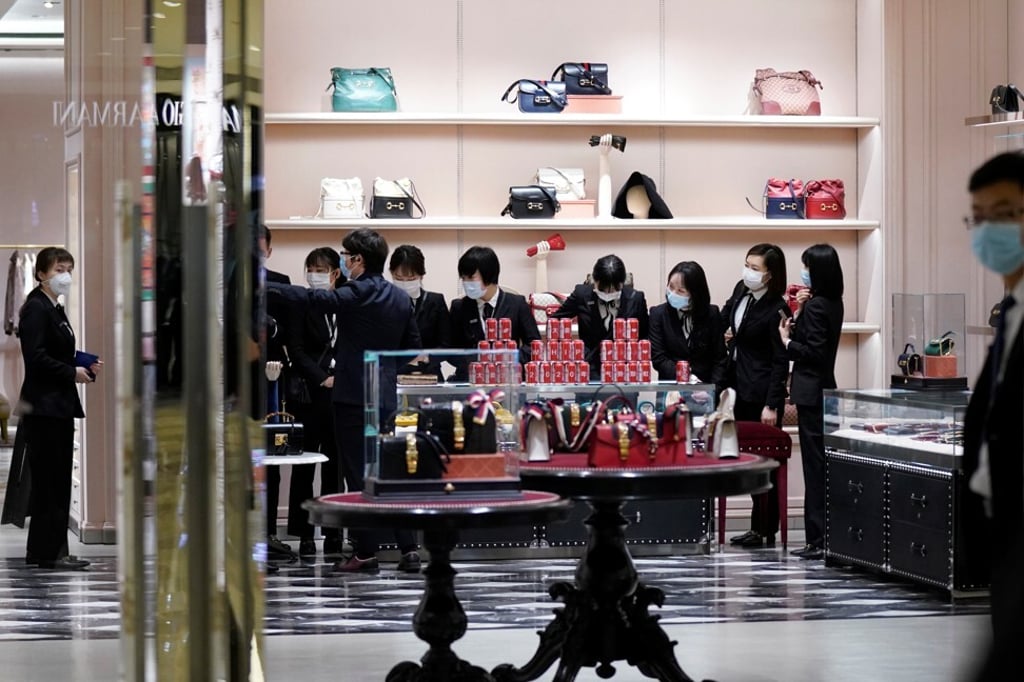 Gucci staff prepare for a ceremony inside a shopping centre as it opens in Wuhan on March 30. Photo: Reuters