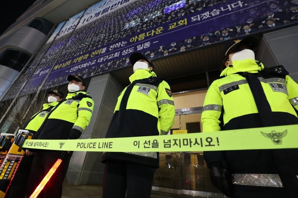 South Korean police officers in front of the Shincheonji Church of Jesus in Daegu, which was the centre of the country's single largest infection cluster. Photo: EPA-EFE