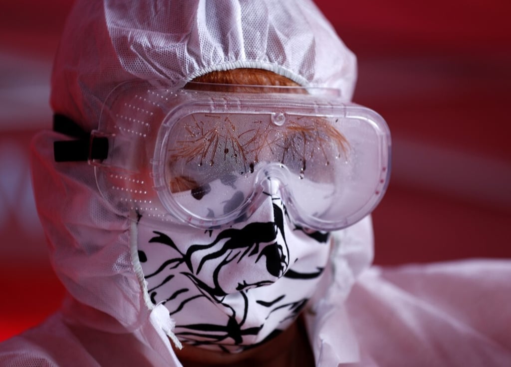 A volunteer with the Red Cross wears a home-made face mask in Prague, the Czech Republic. Photo: AP
