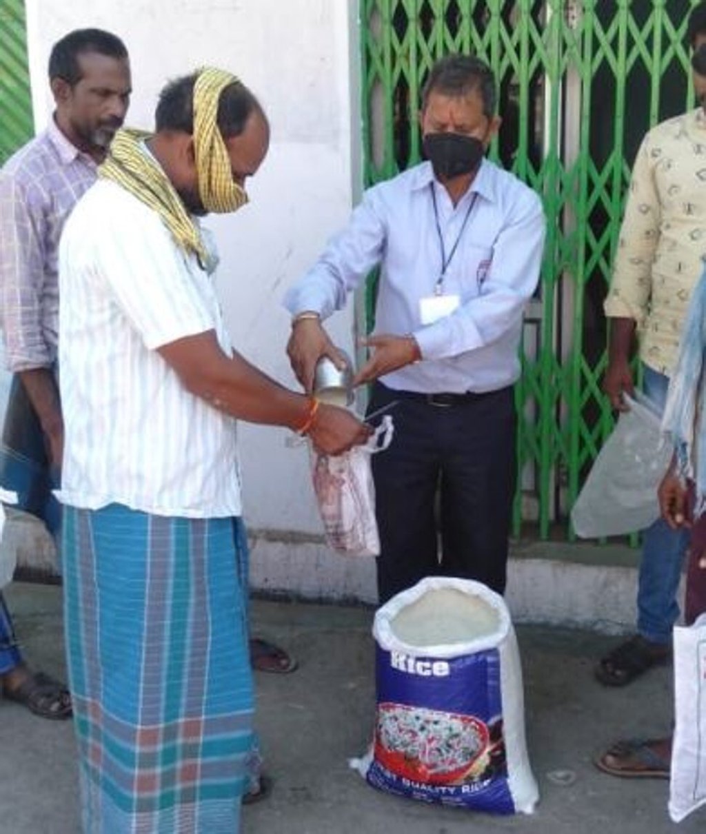 Stranded Indian truckers receive donations of rice. Photo: Ananth