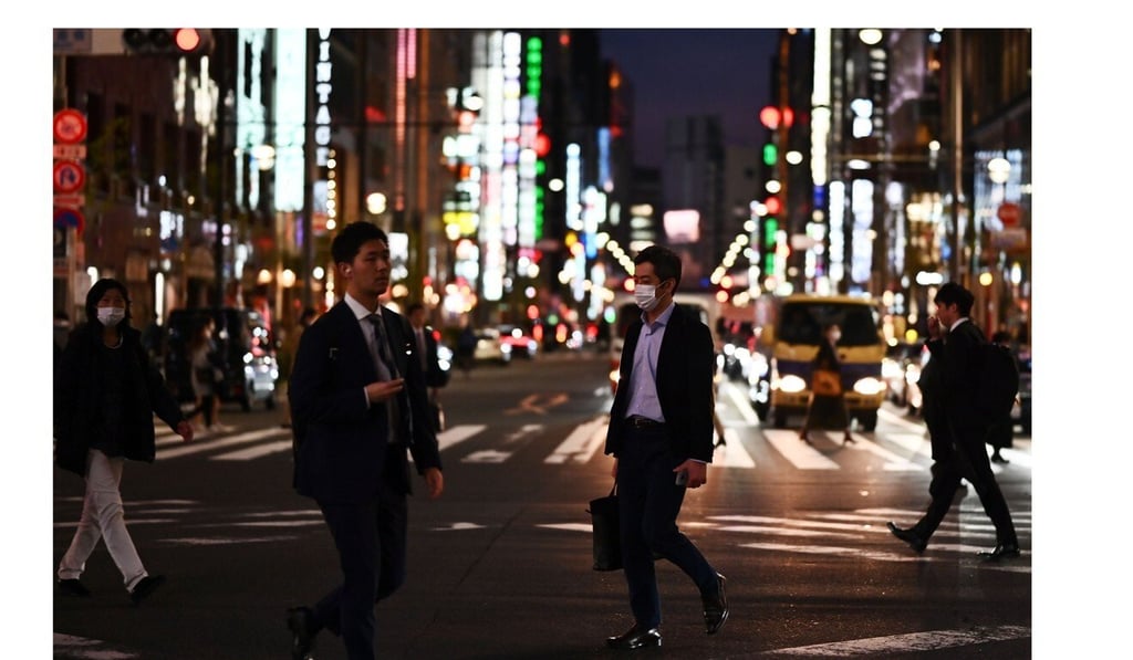 People wearing face masks cross a street in Tokyo's Ginza area. Photo: AFP People wearing face masks cross a street in Tokyo's Ginza area. Photo: AFP