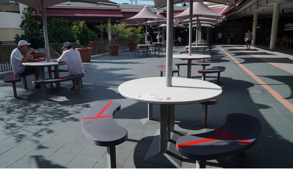 Seats are taped up at a food centre in Singapore to encourage social distancing. Photo: Reuters Seats are taped up at a food centre in Singapore to encourage social distancing. Photo: Reuters
