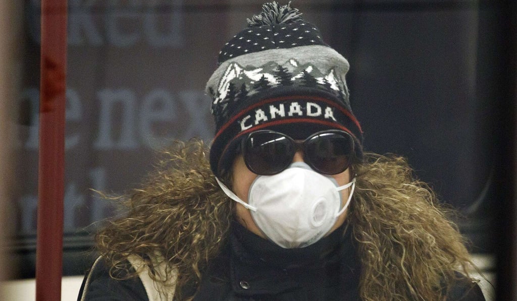 A woman is seen wearing a mask in the Toronto subway on Wednesday. Photo: AFP