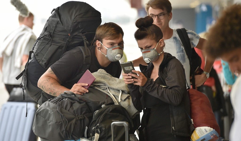 Backpackers queue to enter Sydney's international airport on Thursday. Photo: AFP