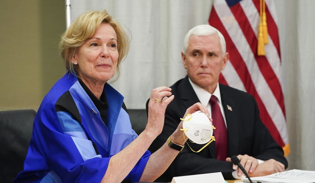 Dr Deborah Birx, White House coronavirus response coordinator, holds a 3M N95 mask as Vice President Mike Pence looks on. Photo: AP Dr Deborah Birx, White House coronavirus response coordinator, holds a 3M N95 mask as Vice President Mike Pence looks on. Photo: AP