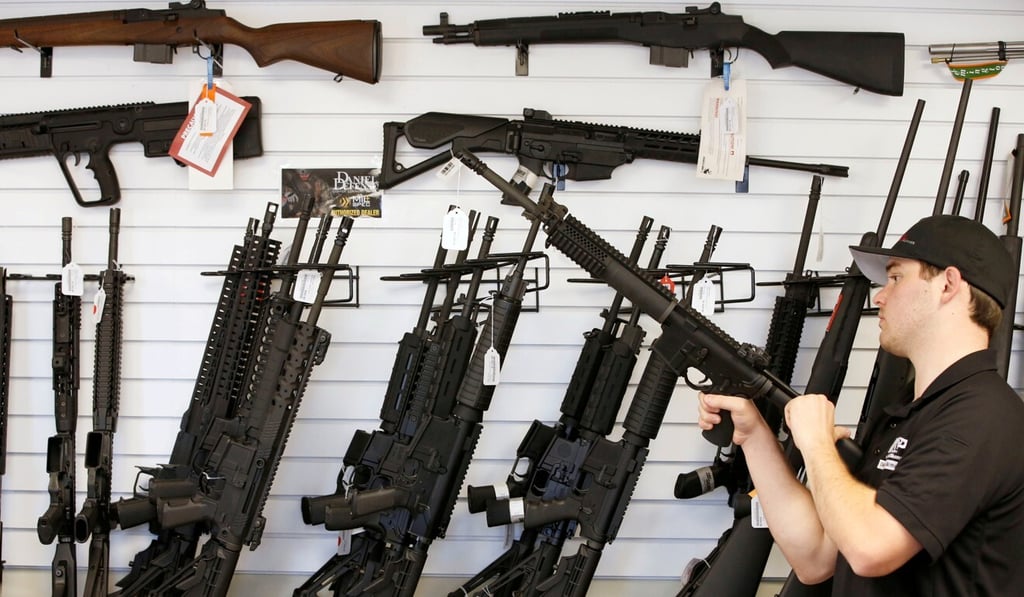 A salesman clears the chamber of an AR-15 at the “Ready Gunner” gun store In Provo, Utah. Photo: Reuters A salesman clears the chamber of an AR-15 at the “Ready Gunner” gun store In Provo, Utah. Photo: Reuters
