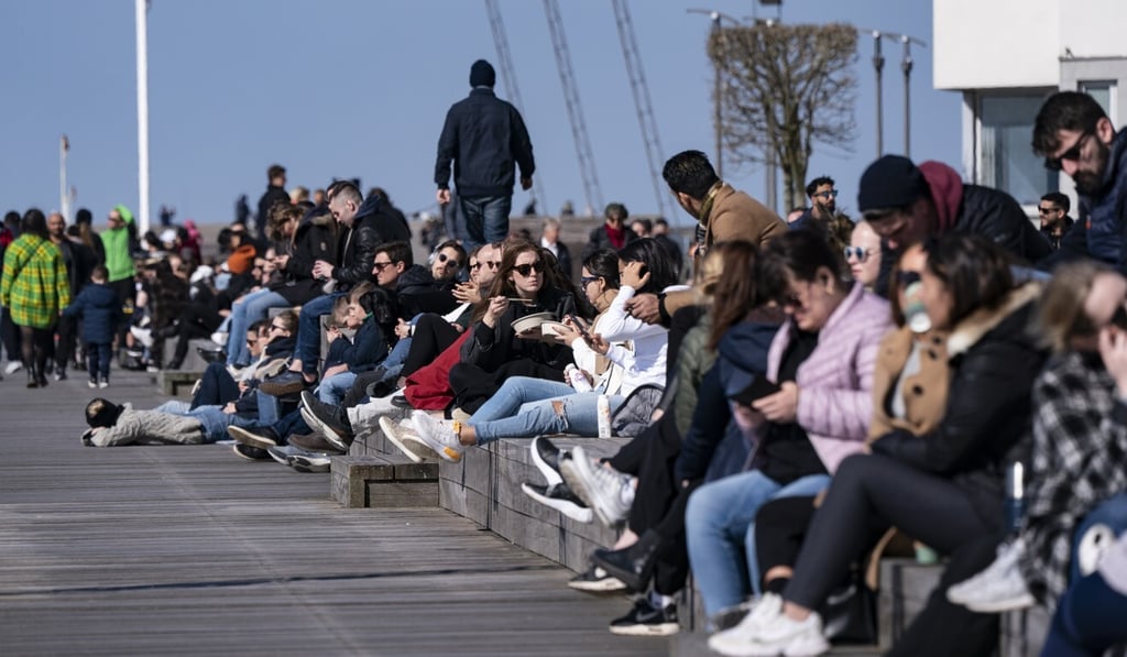 People spend time in the sun in Malmo, Sweden. Photo: EPA