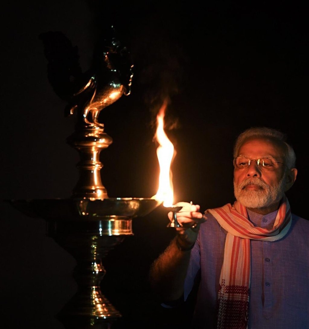 Indian Prime Minister Narendra Modi lights an oil lamp in an image posted to his Twitter account on Sunday. Photo: Twitter via AP Indian Prime Minister Narendra Modi lights an oil lamp in an image posted to his Twitter account on Sunday. Photo: Twitter via AP