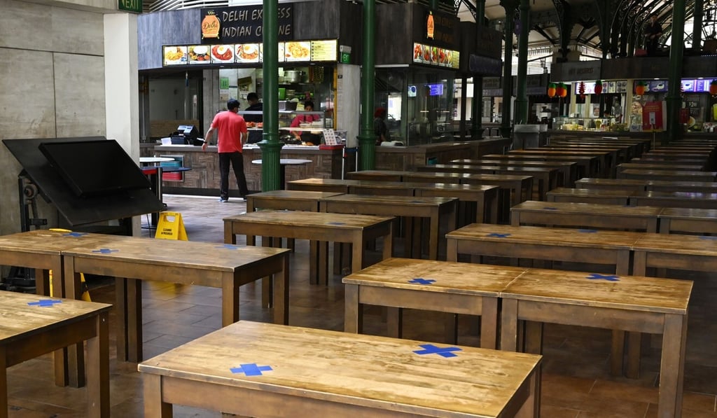 Table settings with the chairs removed at Lau Pa Sat food centre in Singapore. Photo: AFP