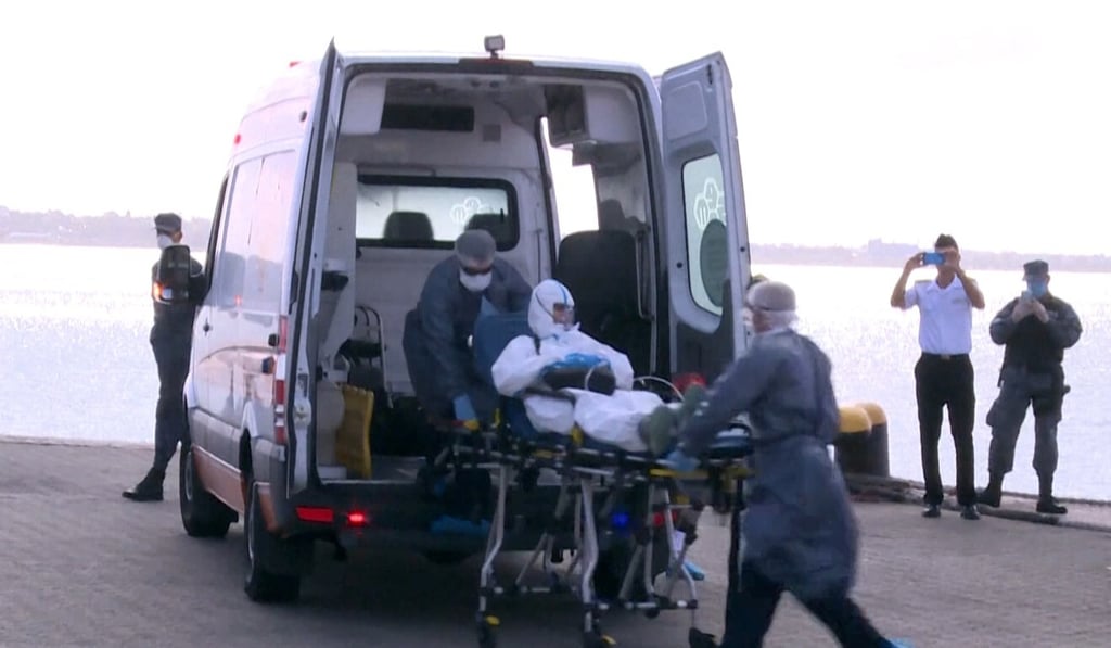 A 75-year-old Australian passenger of the Greg Mortimer cruise liner is loaded into an ambulance in Montevideo on Friday. Photo: AFP