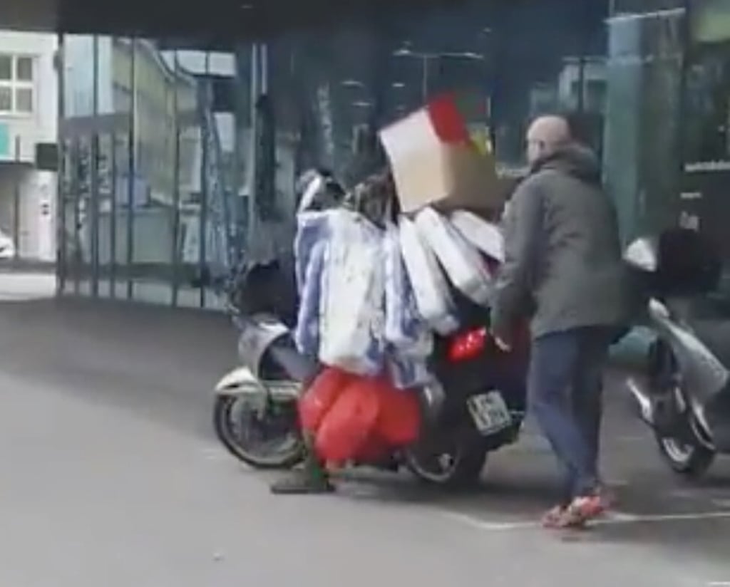 Comparisons have been made between the panic-buying shopper in Innsbruck, Austria with his overloaded scooter, and the legendary porter in video game Death Stranding. Photo: Twitter/@zinnaglism