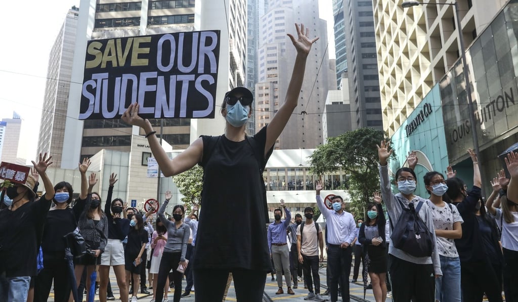 Masked protesters at a lunchtime rally. Photo: Nora Tam