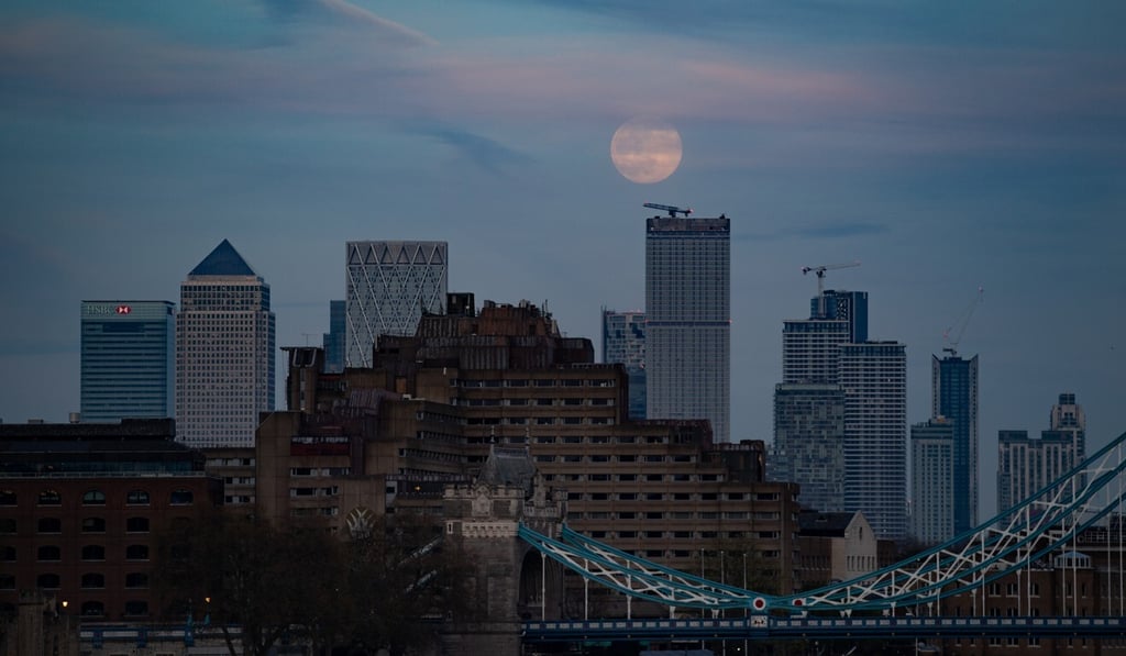 The pink supermoon rises over Canary Wharf in London on Tuesday. Photo: dpa The pink supermoon rises over Canary Wharf in London on Tuesday. Photo: dpa