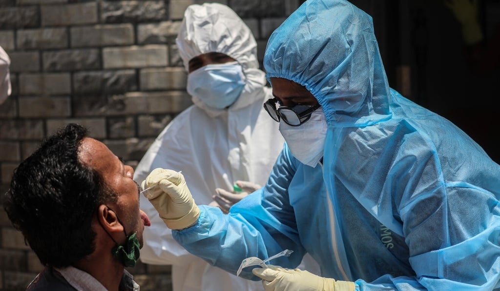 A medical team takes a saliva sample for testing from a man in Mumbai, capital of Maharashtra state. Photo: EPA A medical team takes a saliva sample for testing from a man in Mumbai, capital of Maharashtra state. Photo: EPA
