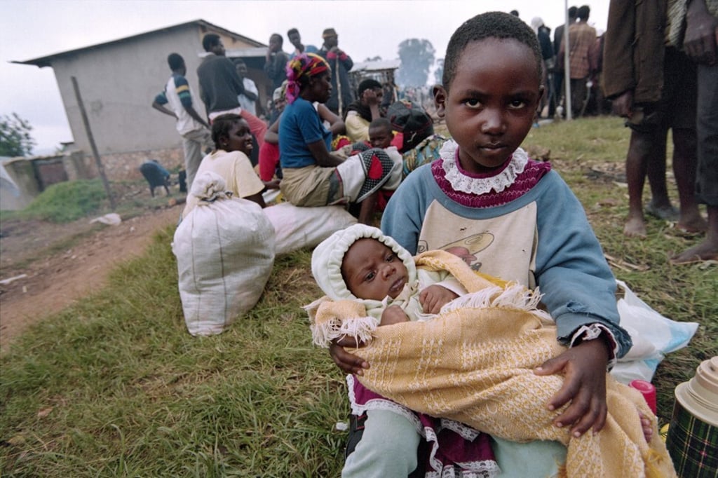 A young girl, flees the war-ravaged Rwandan capital, Kigali, in 1994. Photo: AFP