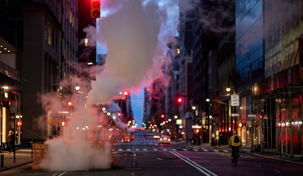 A man rides his bike on an empty street in New York City on Friday amid the coronavirus pandemic. Photo: AFP