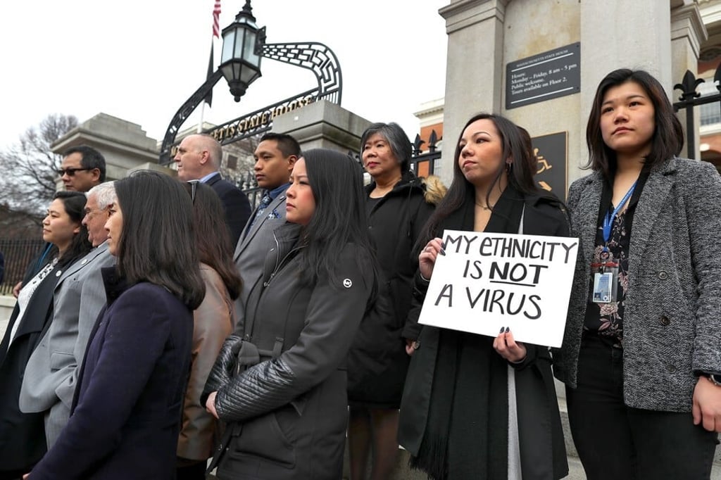 Members of the Asian American Commission hold a press conference on the steps of the Massachusetts State House to condemn racism towards the Asian-American community because of the coronavirus on March 12 in Boston. Photo: Getty Images