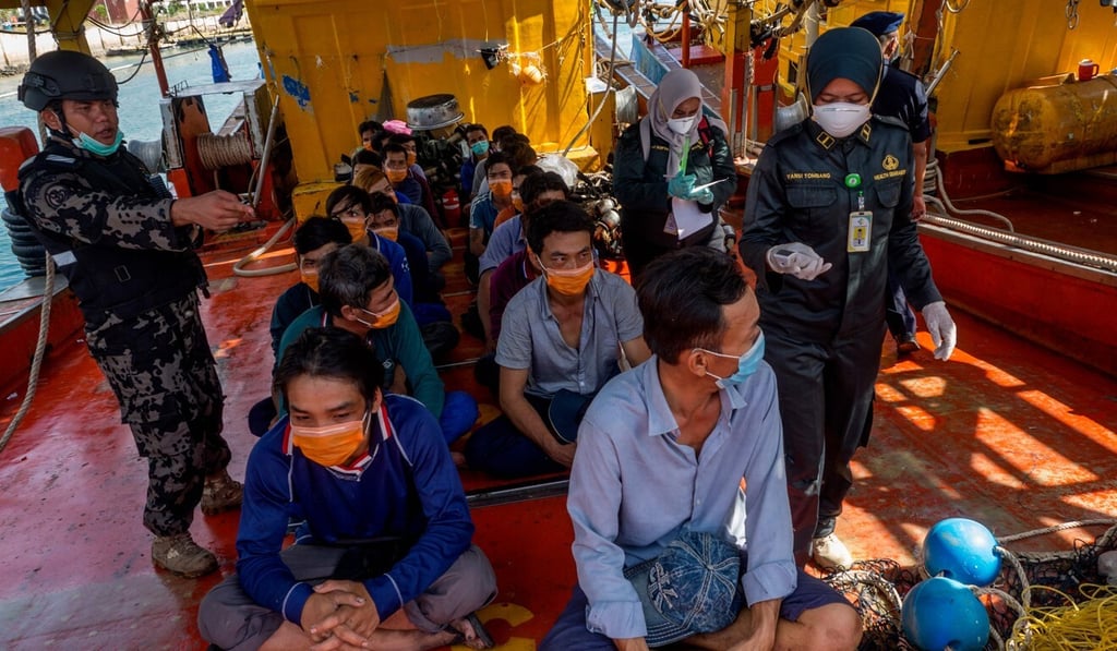 Indonesian officers watch over Vietnamese fishing crew who have been detained for fishing illegally in the South China Sea, on March 4 in Batam, Riau Islands. Illegal, unreported and unregulated fishing is rife in the area. Photo: AFP