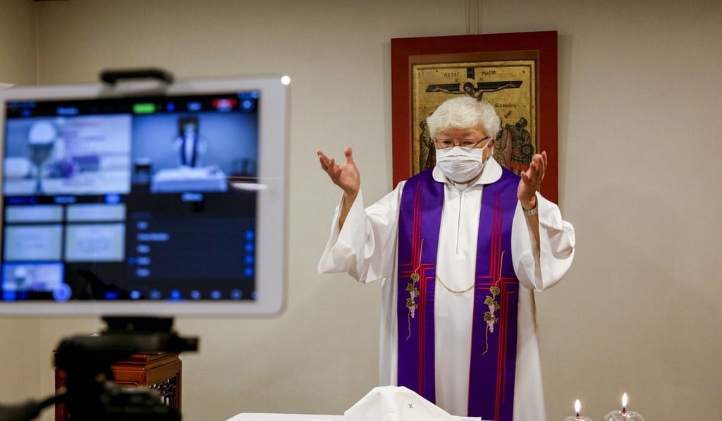 A priest conducts a service streamed online for church-goers, after the Roman Catholic Diocese of Hong Kong temporarily suspended public masses at churches in March. Photo: Reuters