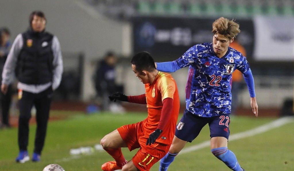 Li watches China play Japan in the EAFF E-1 Football Championship in Busan, South Korea. Photo: EPA