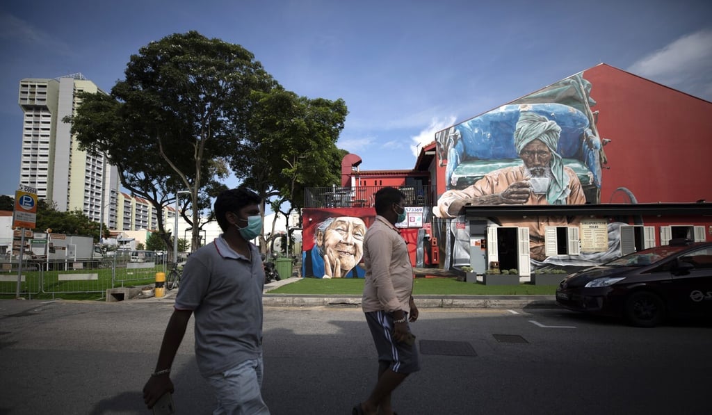 People wearing protective face masks walk in Singapore’s Little India district. Photo: EPA People wearing protective face masks walk in Singapore’s Little India district. Photo: EPA