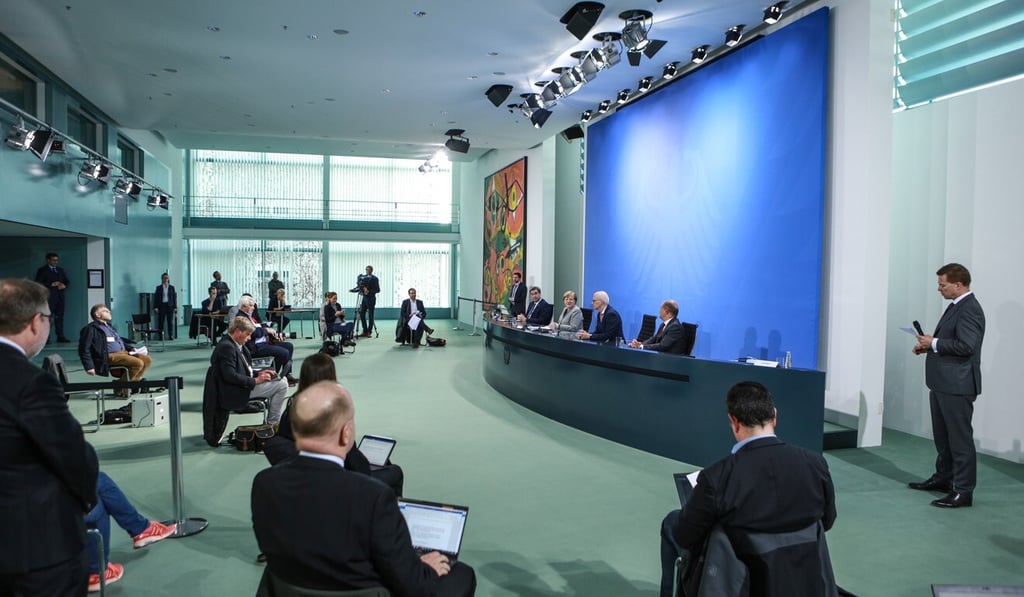Reporters practice social distancing at the chancellery in Berlin on Wednesday during a government press conference led by German Chancellor Angela Merkel. Photo: EPA-EFE Reporters practice social distancing at the chancellery in Berlin on Wednesday during a government press conference led by German Chancellor Angela Merkel. Photo: EPA-EFE