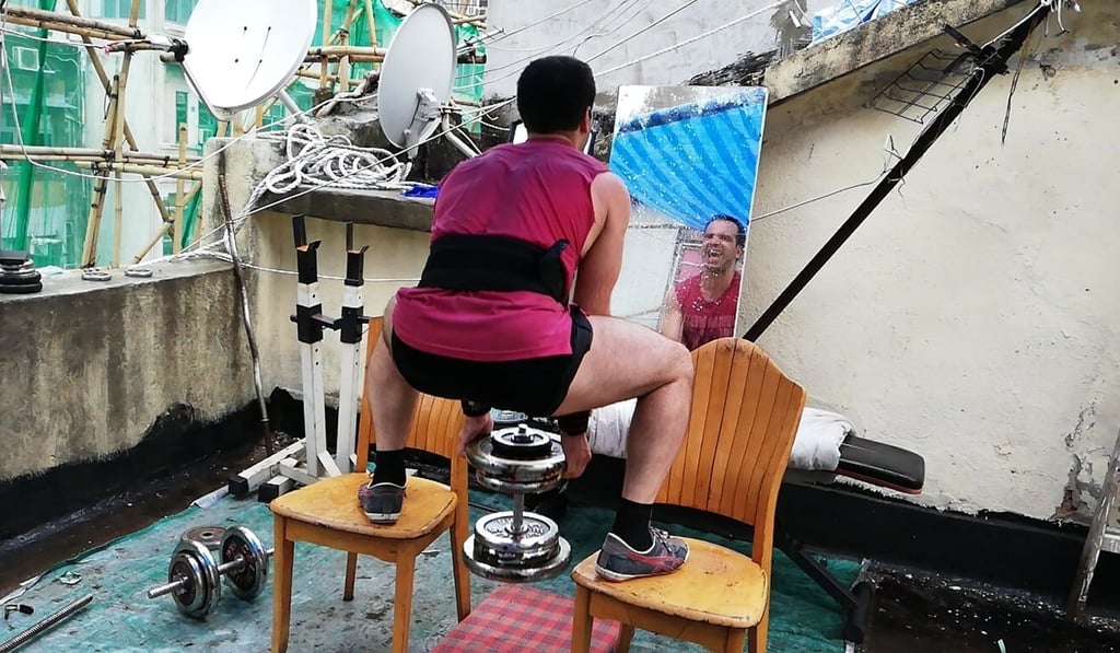 Unable to afford a gym, Alex Tyronne works out on his roof with makeshift equipment.