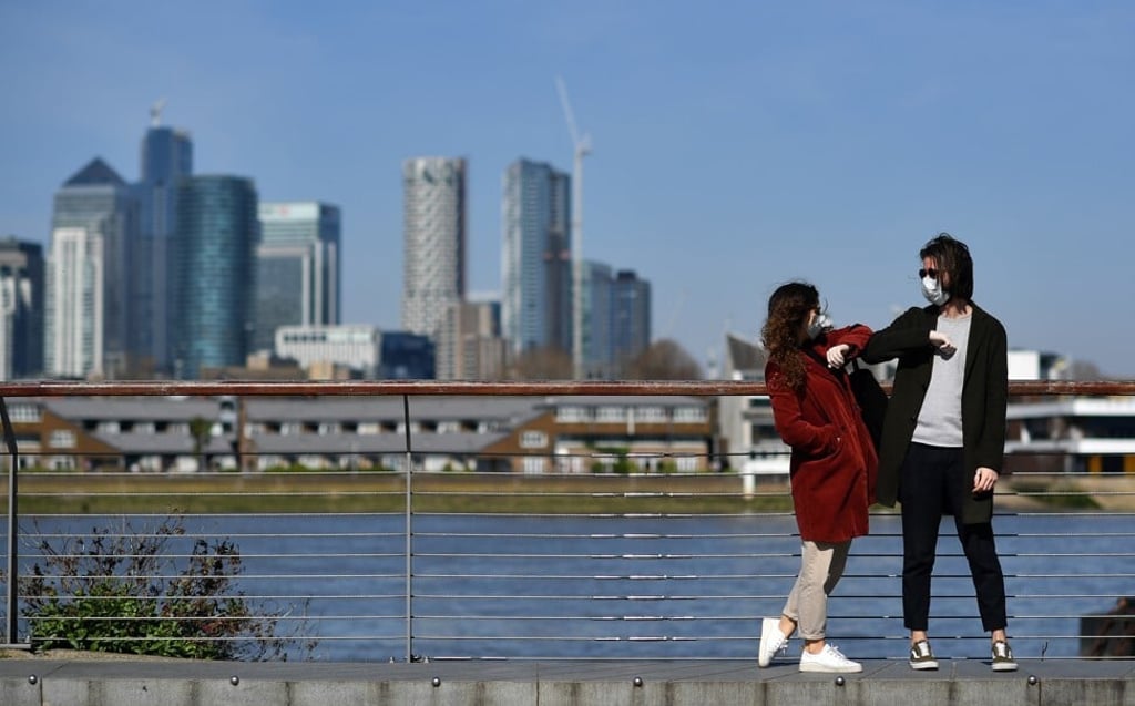 Handshakes are out, and elbow bumps like this one in south London may become more common. Photo: AFP via Getty Images