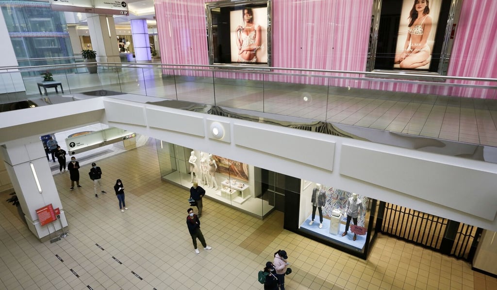 People line up to buy groceries in the near-empty Metrotown mall in Burnaby, British Columbia, on Tuesday. Photo: Xinhua