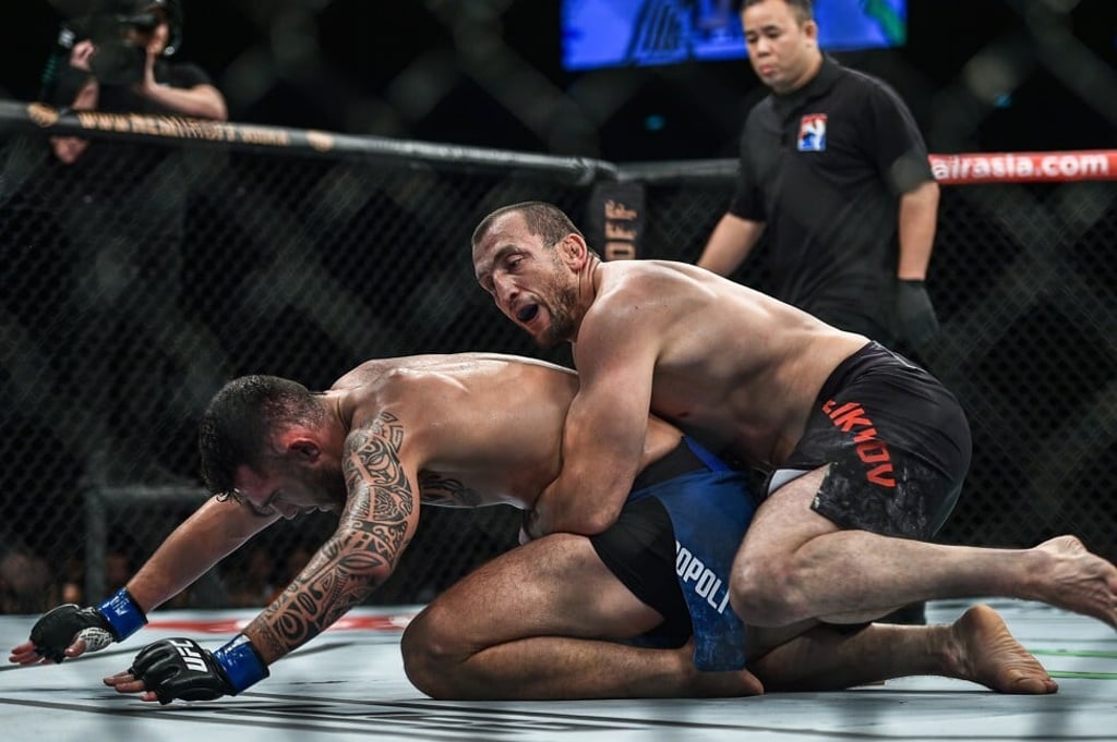 Muslim Salikhov grabs hold of Laureano Staropoli on the ground. Muslim Salikhov grabs hold of Laureano Staropoli on the ground.