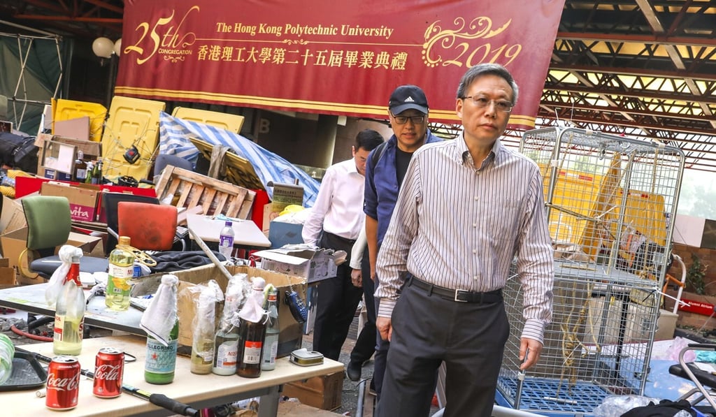 Polytechnic University president Professor Teng Jin-guang surveys the damage to the campus after the occupation by protesters last November. Photo: Dickson Lee