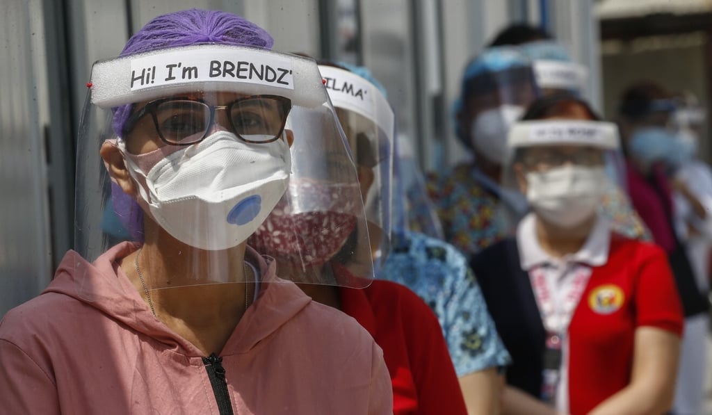 Medical workers wear protective masks with their names on at a hospital in Manila, the Philippines. Photo: EPA