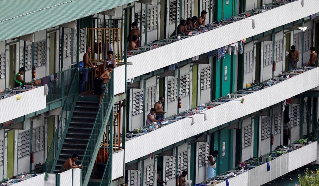 Migrant workers are pictured outside their rooms at a dormitory in Singapore earlier this month. Photo: Reuters