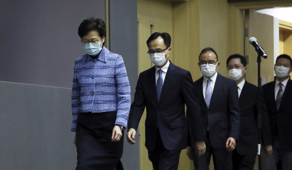 Chief Executive Carrie Lam and the new civil service chief secretary, Patrick Nip (second left), along with the other new appointees, meet the press on Wednesday. Photo: AP Chief Executive Carrie Lam and the new civil service chief secretary, Patrick Nip (second left), along with the other new appointees, meet the press on Wednesday. Photo: AP