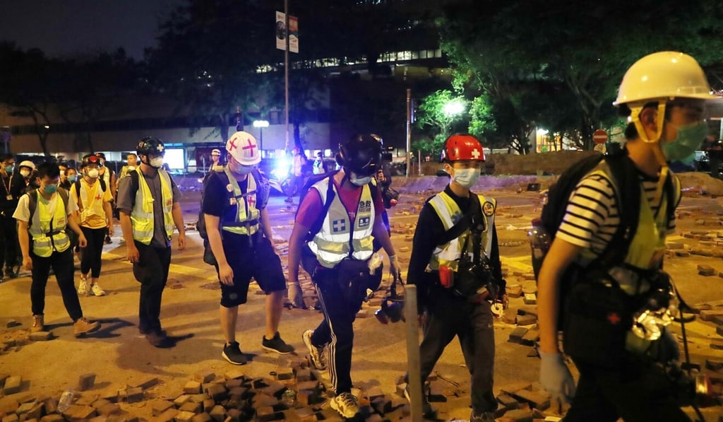 First aid volunteers are allowed to leave the Polytechnic University campus after their identities were recorded by police in November. Photo: Sam Tsang