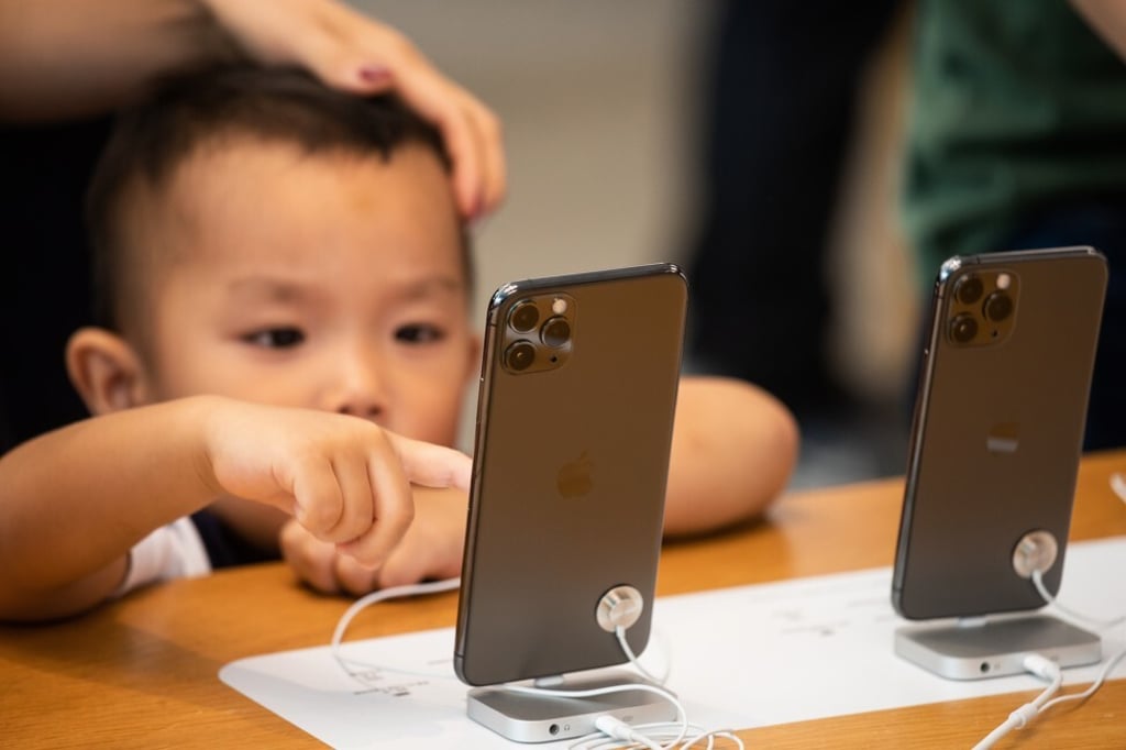 A child tries an iPhone 11 Pro Max at an Apple Store in Hong Kong in September of last year. Apple is working on three of its own Mac processors, known as systems-on-a-chip, based on the A14 processor in the next iPhone. Photo: Bloomberg