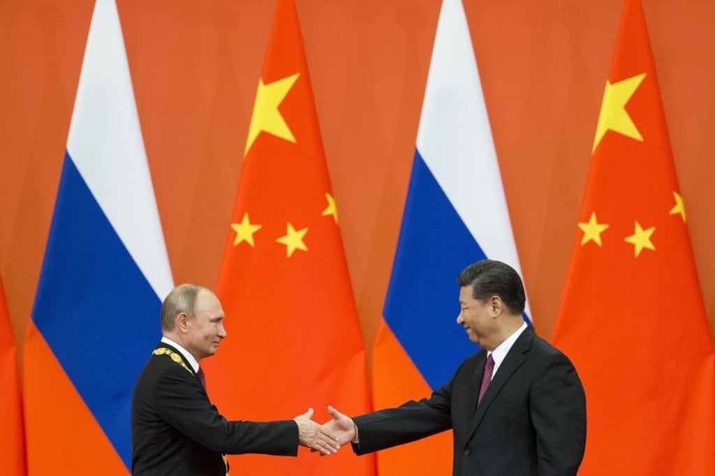 Chinese President Xi Jinping and his Russian counterpart Vladimir Putin shake hands during a 2018 award ceremony at the Great Hall of the People in Beijing. Photo: AP