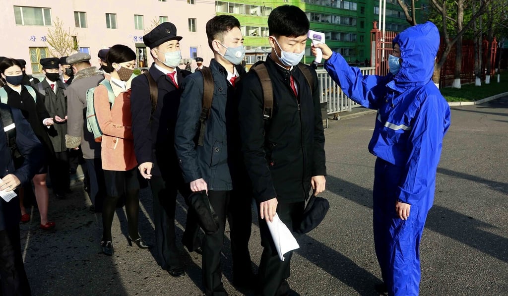 Students wearing face masks have their temperature checked at Kim Chaek University of Technology in Pyongyang. Photo: AP Students wearing face masks have their temperature checked at Kim Chaek University of Technology in Pyongyang. Photo: AP