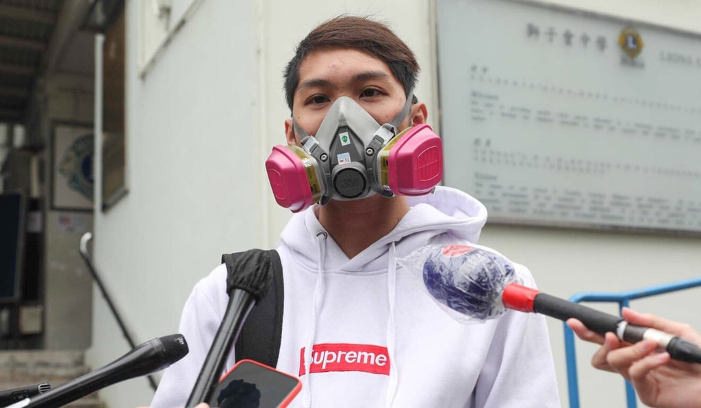 Lam Wai-lok, 18, wears a respirator while working on his paper. Photo: Xiaomei Chen
