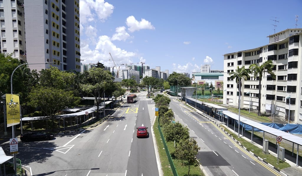 Vehicles travel along a near-deserted road in Singapore during a partial lockdown imposed due to the coronavirus. Photo: Bloomberg