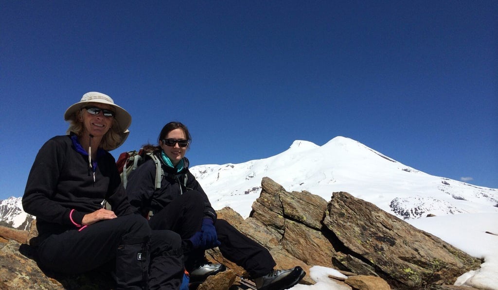 Sophie Cairns and friend Tina Bowman on an acclimatisation hike on Mount Cheget, Russia, as preparation for climbing Mount Elbrus, whose West Summit can be seen in the background.