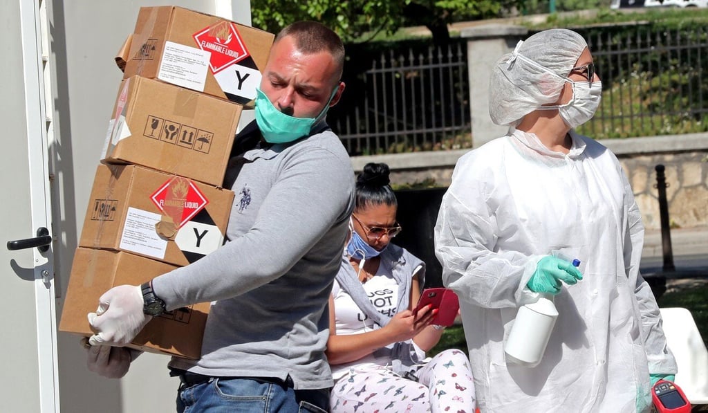 A worker carries packages of medical equipment to a hospital in Sarajevo, Bosnia and Herzegovina on Tuesday. Photo: EPA-EFE
