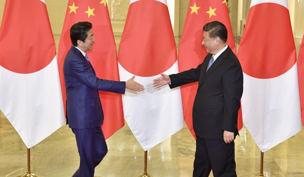 Chinese President Xi Jinping (right) welcomed Japanese Prime Minister Shinzo Abe to Beijing in December. Photo: Kyodo