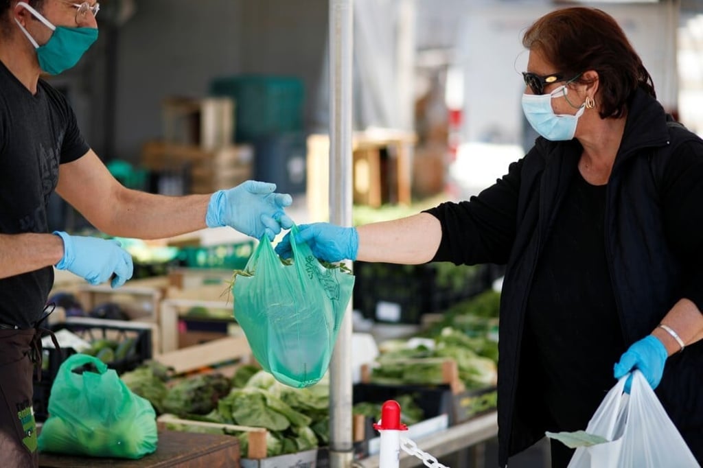 A vendor delivers goods at a reopened food market in Cisternino, Italy, on Monday. Some European nations, such as hard-hit Italy, are beginning to ease coronavirus restrictions. Photo: Reuters