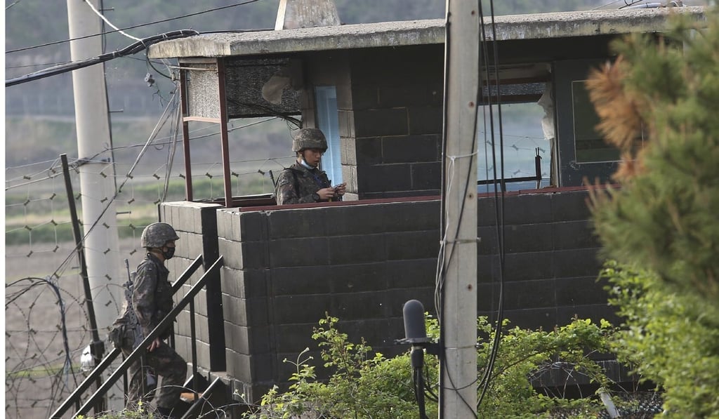 Army soldiers walk up the stairs of their military guard post in Paju, South Korea, near the border with North Korea. Photo: AP
